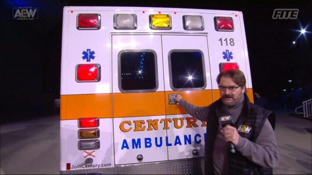 AEW photo of ambulance and Tony Schiavone pointing at it