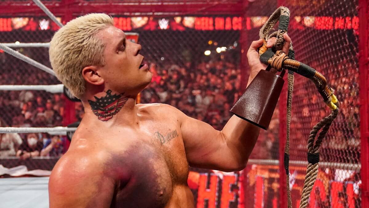 Cody Rhodes with a cowbell inside Hell in a Cell