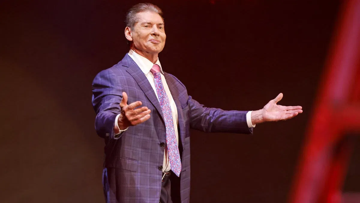 Vince McMahon stands proudly in a suit