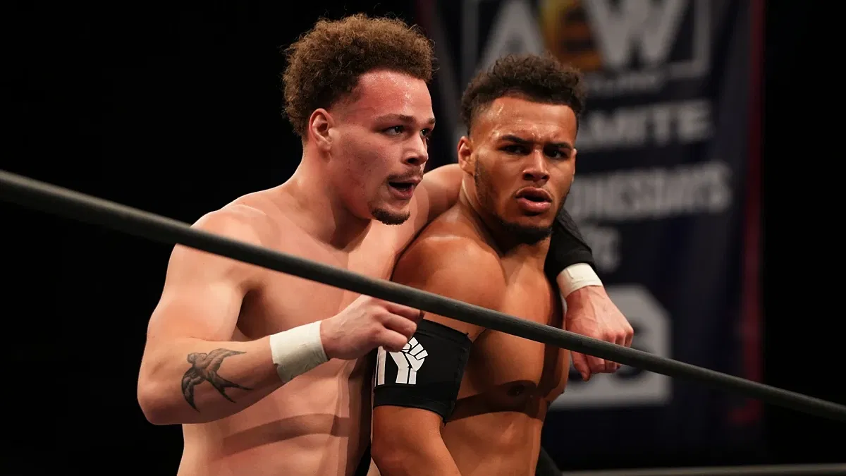 Dante and Darius Martin of Top Flight standing in the ring following a match