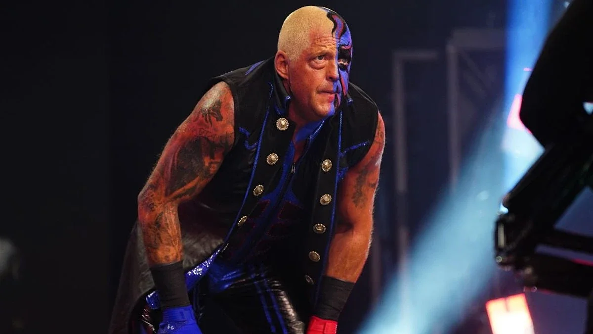 Dustin Rhodes looking concerned standing on the stage