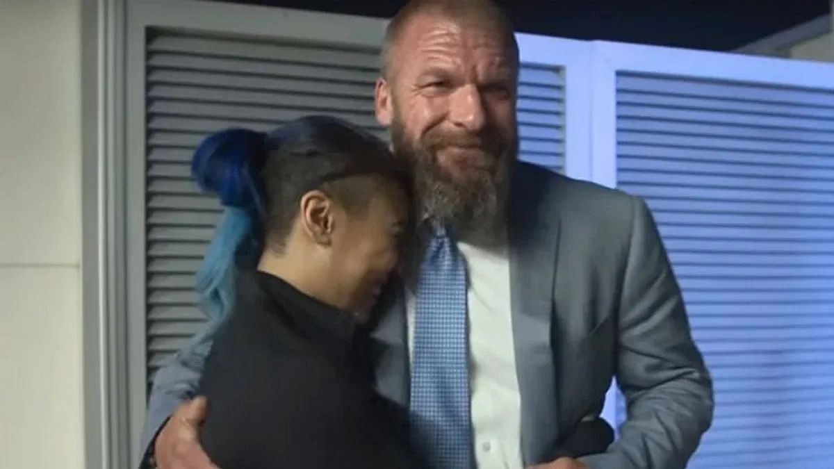 Mia Yim hugging Triple H