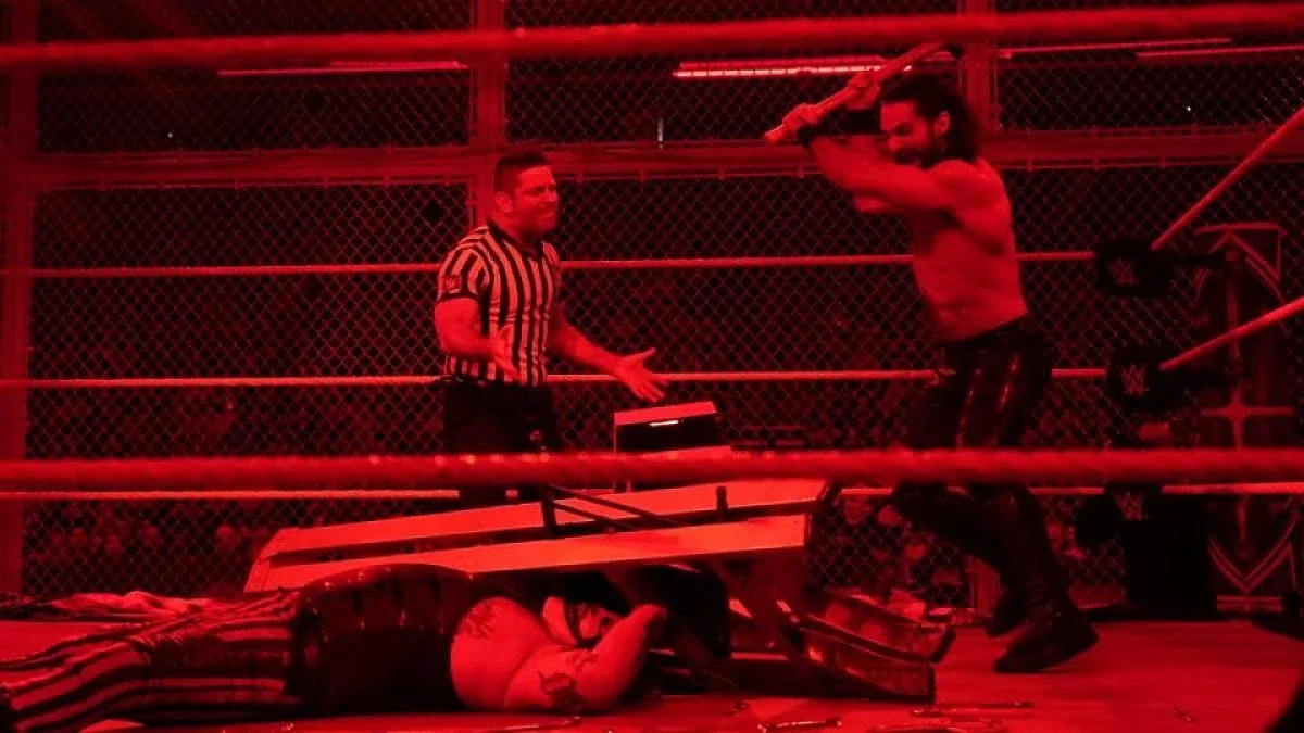 Seth Rollins hitting 'The Fiend' Bray Wyatt with a sledgehammer inside Hell In A Cell in 2019