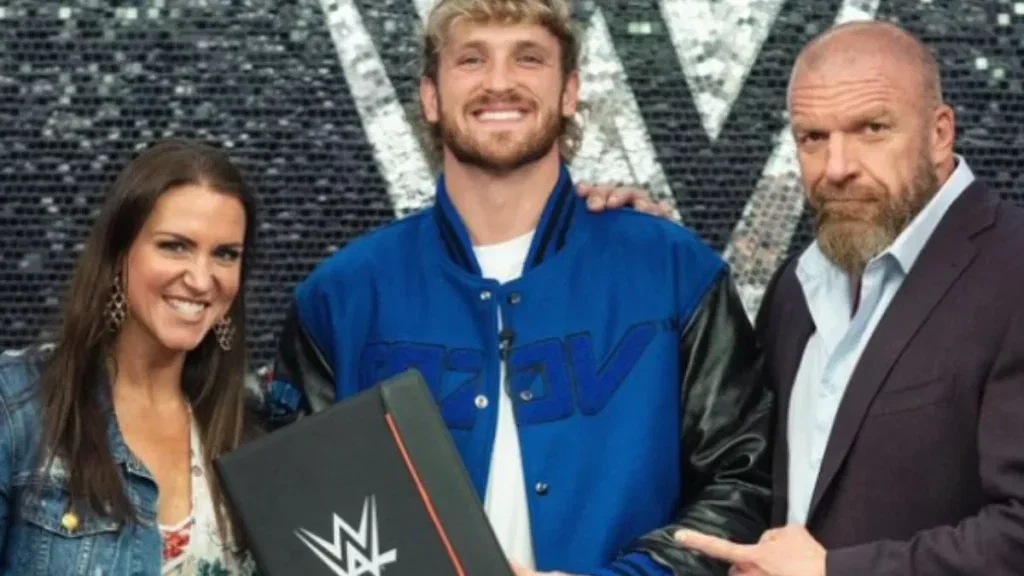 Logan Paul with Stephanie McMahon and Triple H