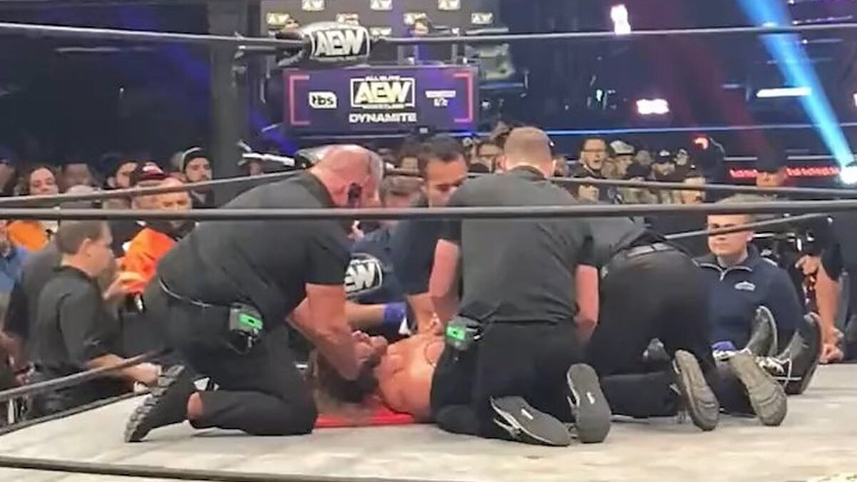 Adam Page being checked on by doctors 