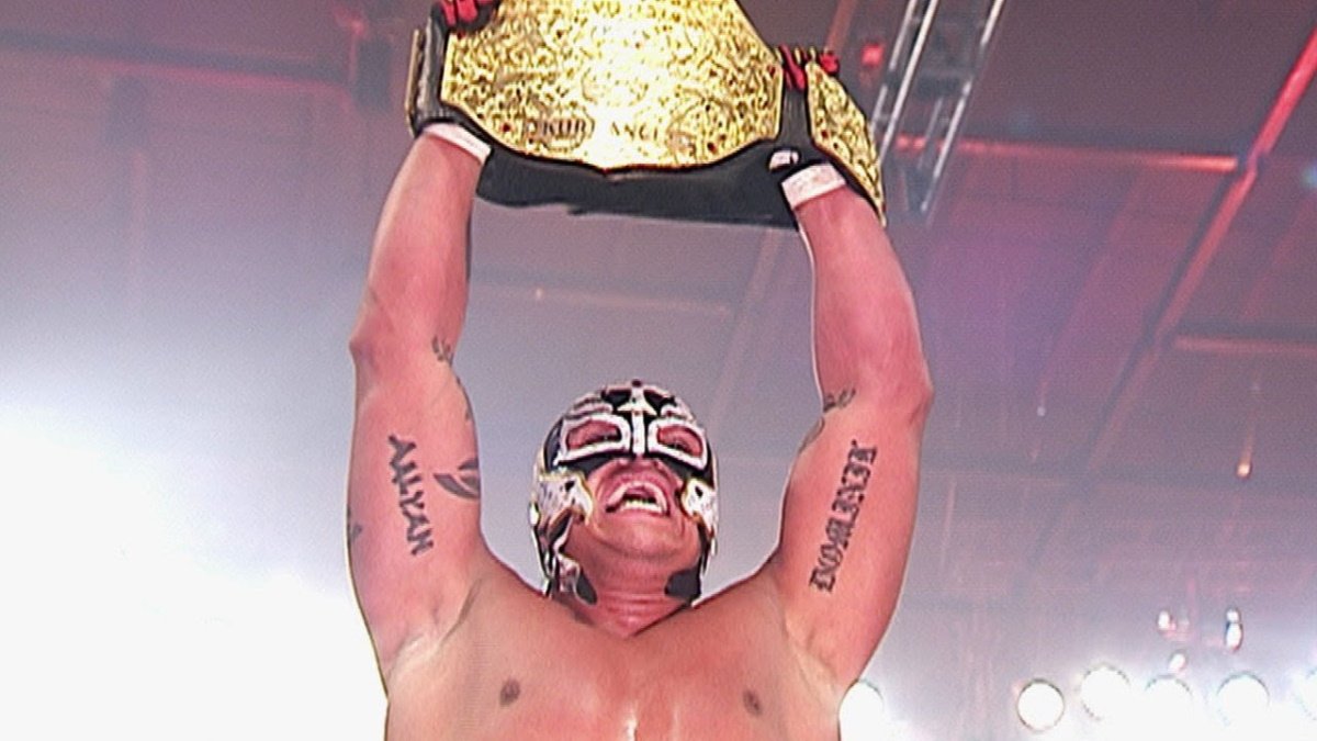 Rey Mysterio celebrates winning his first WWE World Championship at WrestleMania 22