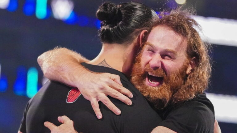 WWE star Sami Zayn hugging Roman Reigns