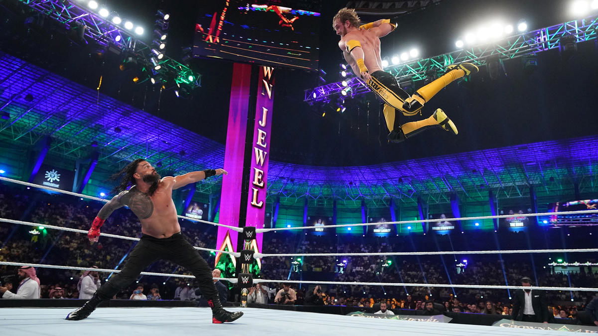 Logan Paul flying towards Roman Reigns