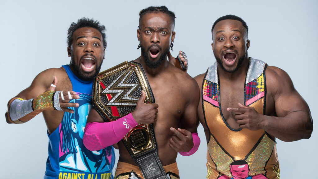 The New Day with Kofi Kingston holding the WWE Championship.