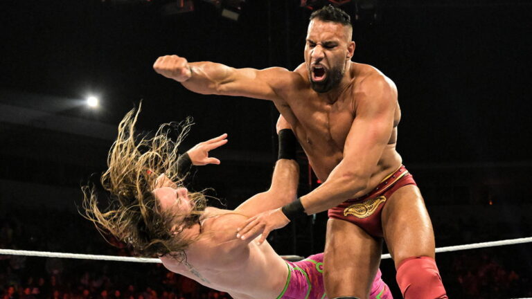 Jinder Mahal clotheslining Seth Rollins in a WWE ring