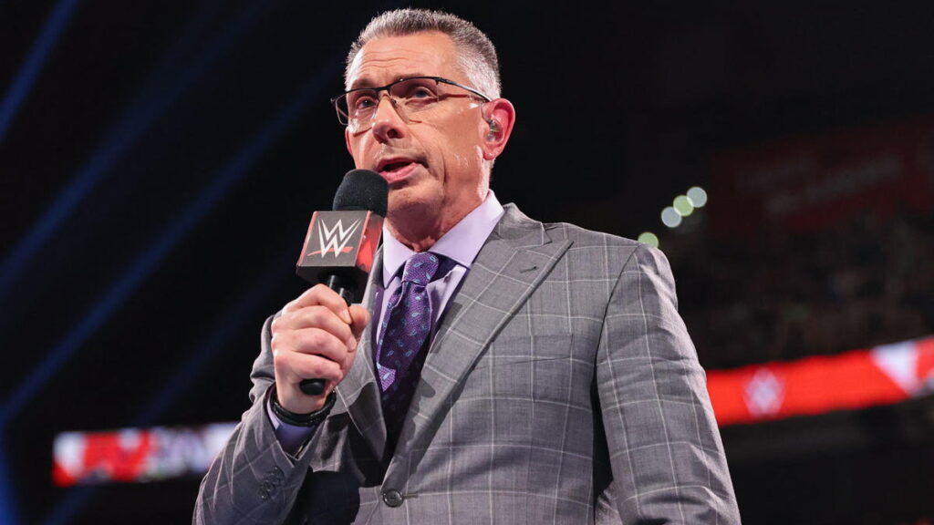 WWE commentator Michael Cole in ring with microphone