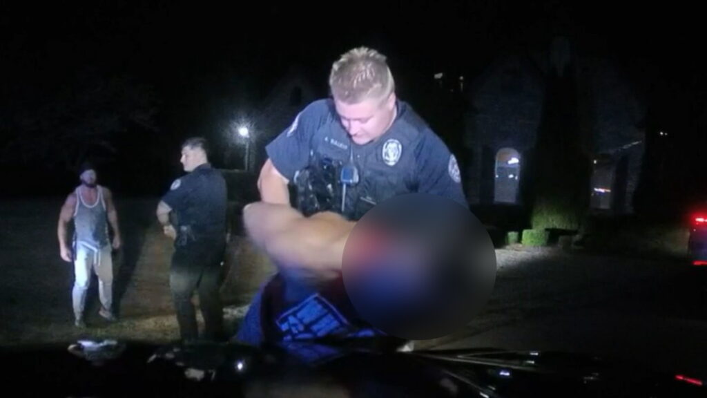 WWE SmackDown still of LA Knight being detained by police at AJ Styles' home on the show