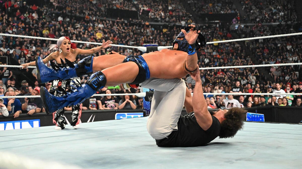 WWE star Carlito hitting a backstabber on Dragon Lee.
