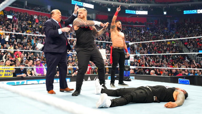 The Bloodline members Solo Sikoa, Tama Tonga and Paul Heyman standing over Jimmy Uso On April 12 WWE SmackDown