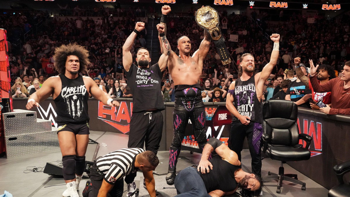 WWE Judgment Day faction members Damian Priest, Finn Balor, Carlito and JD McDonagh standing over Drew McIntyre