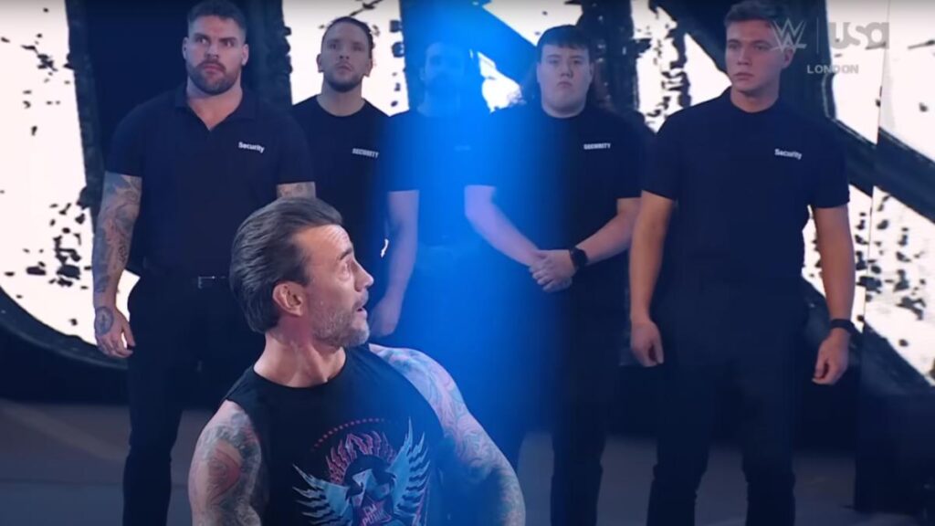 CM Punk looking at WWE security guards