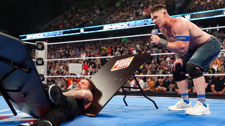 John Cena and CM Punk through a table on WWE SmackDown