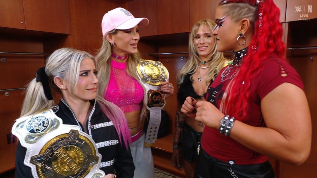 WWE Women's Tag Team Champions Charlotte Flair and Alexa Bliss next to Sol Ruca and Zaria
