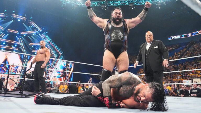 Bronson Reed standing over Roman Reigns at WWE Crown Jewel
