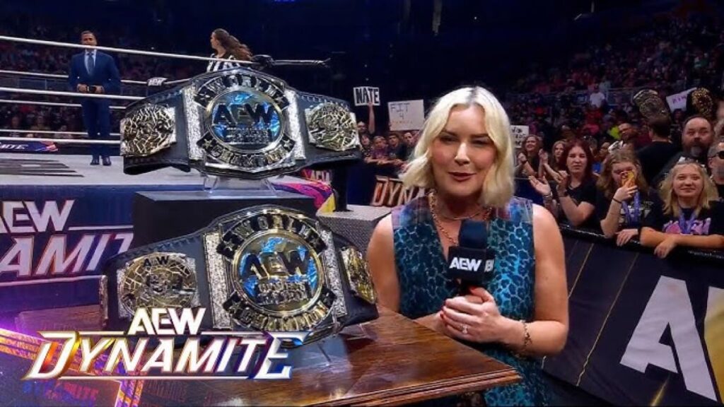 Renee Paquette standing next to the AEW Women's World Tag Team Championship