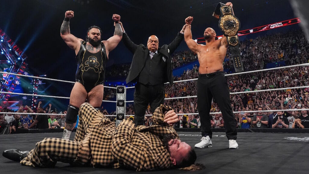 Paul Heyman, Bron Breakker and Bronson Reed standing over Seth Rollins on WWE Raw