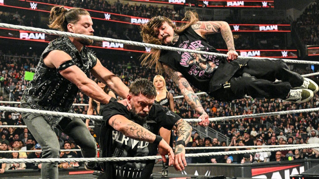 JD McDonagh and Dominik Mysterio beating up Finn Balor on WWE Raw