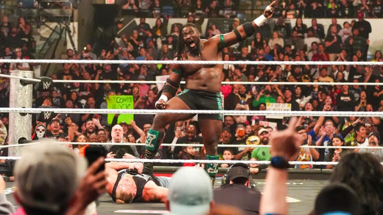 Oba Femi standing over Brock Lesnar on WWE Raw