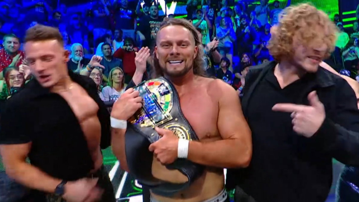 Lexis King as WWE Speed Men's Champion alongside Charlie Dempsey and Channing 'Stacks' Lorenzo