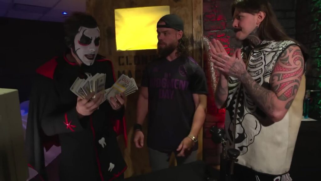 Danhausen with human monies next to JD McDonagh & Dominik Mysterio