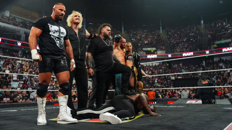 WWE's The Vision standing over Oba Femi on Raw.