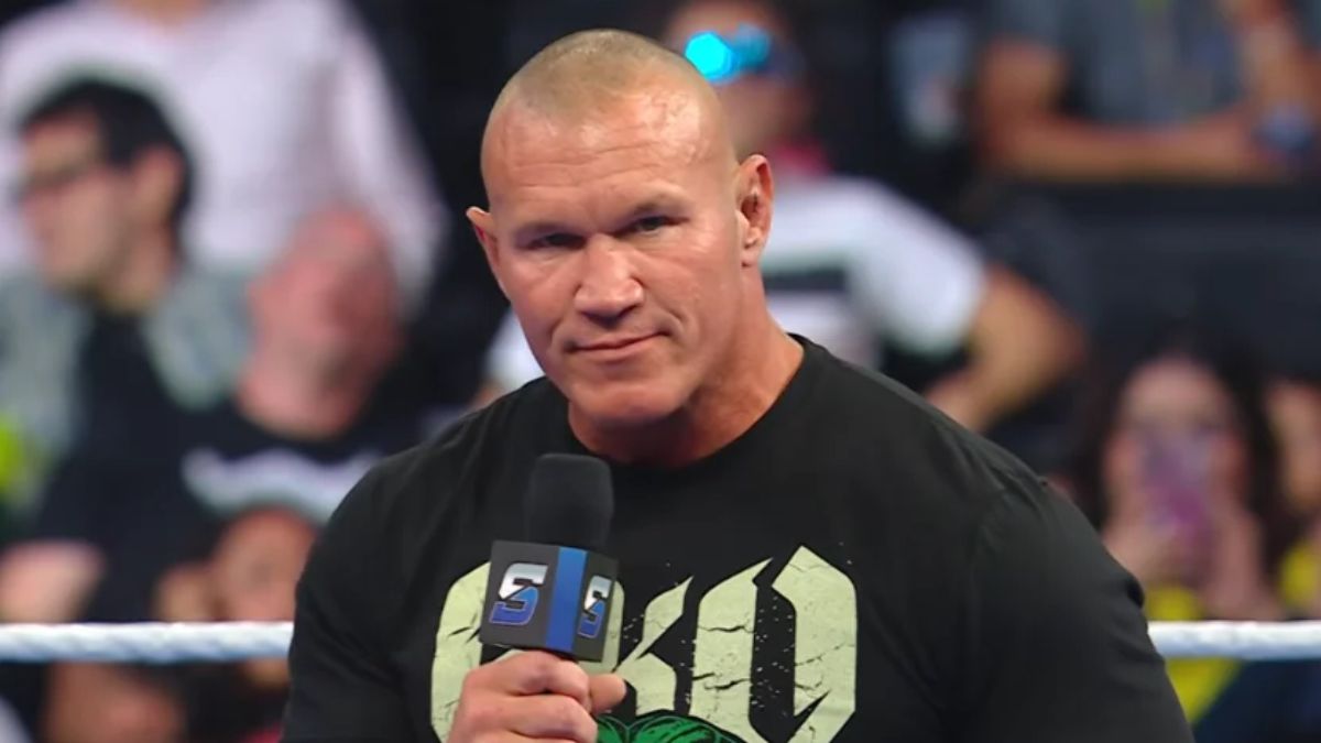 Randy Orton in a WWE ring holding a microphone